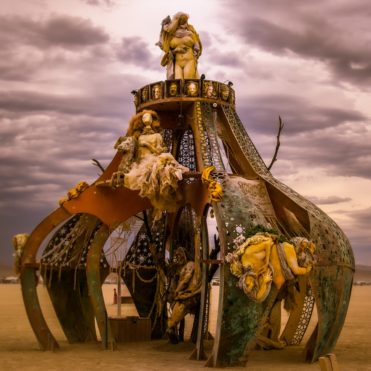 Bottled Up Genie sculpture, an ornate multi-tiered art installation with cast figures and a woman standing at its peak